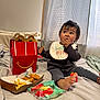 toddler, child, bed, happy_meal, fast_food, nuggets, fries, bib, snack, indoor, curtain, blanket, clothing, foot, eating, messy, face, person, toy, light