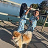 child, boy, girl, dog, pajamas, outdoor, daylight, water, pond, leash, shadow, tree, animal, pet, playful, summer, sky, clothing, fun, nature