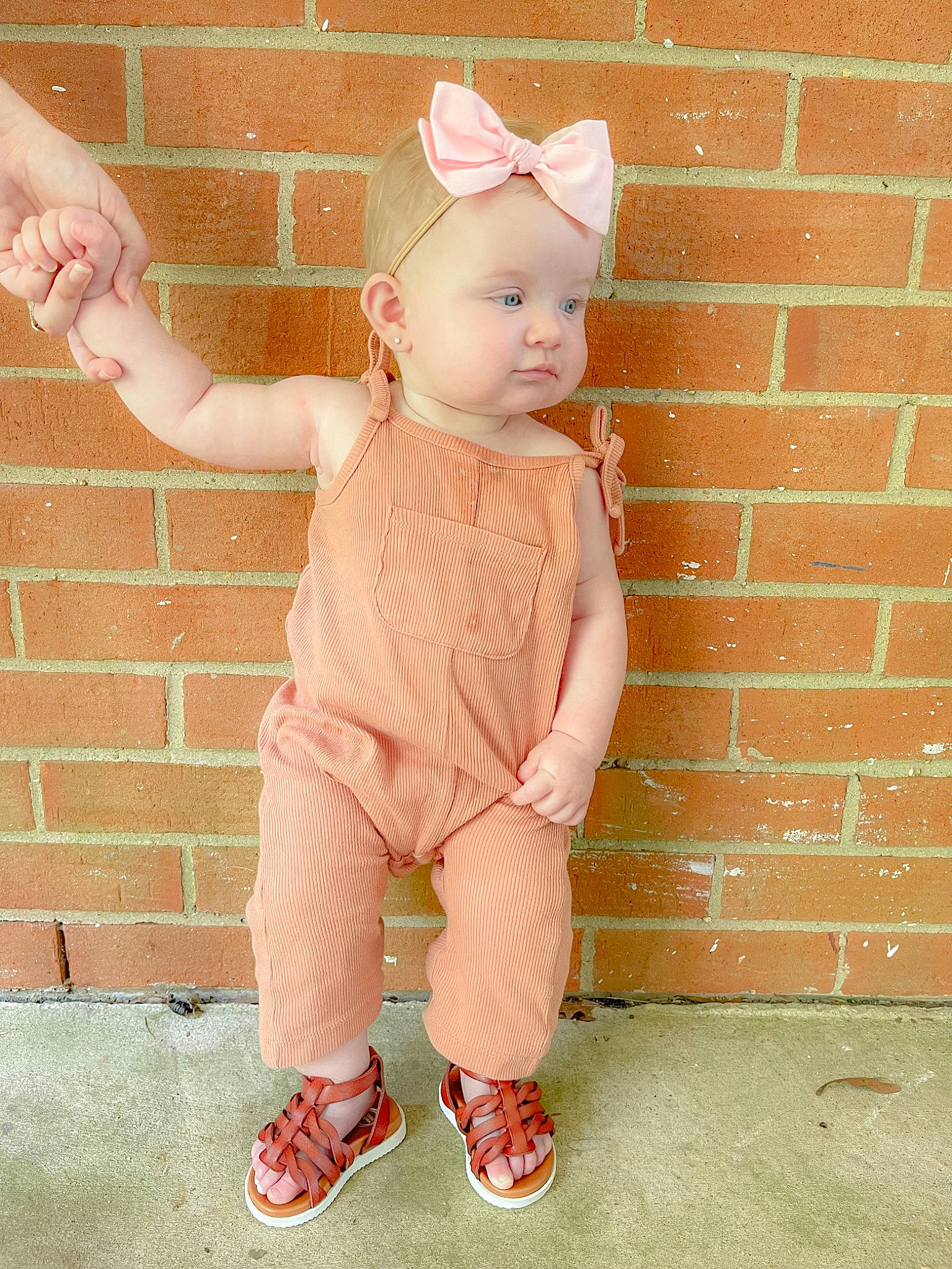 Lucie is registered to the contest to win money with this photo: arm, baby, baby_toddler_clothing, cheek, doll, finger, gesture, hand, happy, head, headgear, human_body, joint, pattern, person, pink, skin, sleeve, thumb, toy