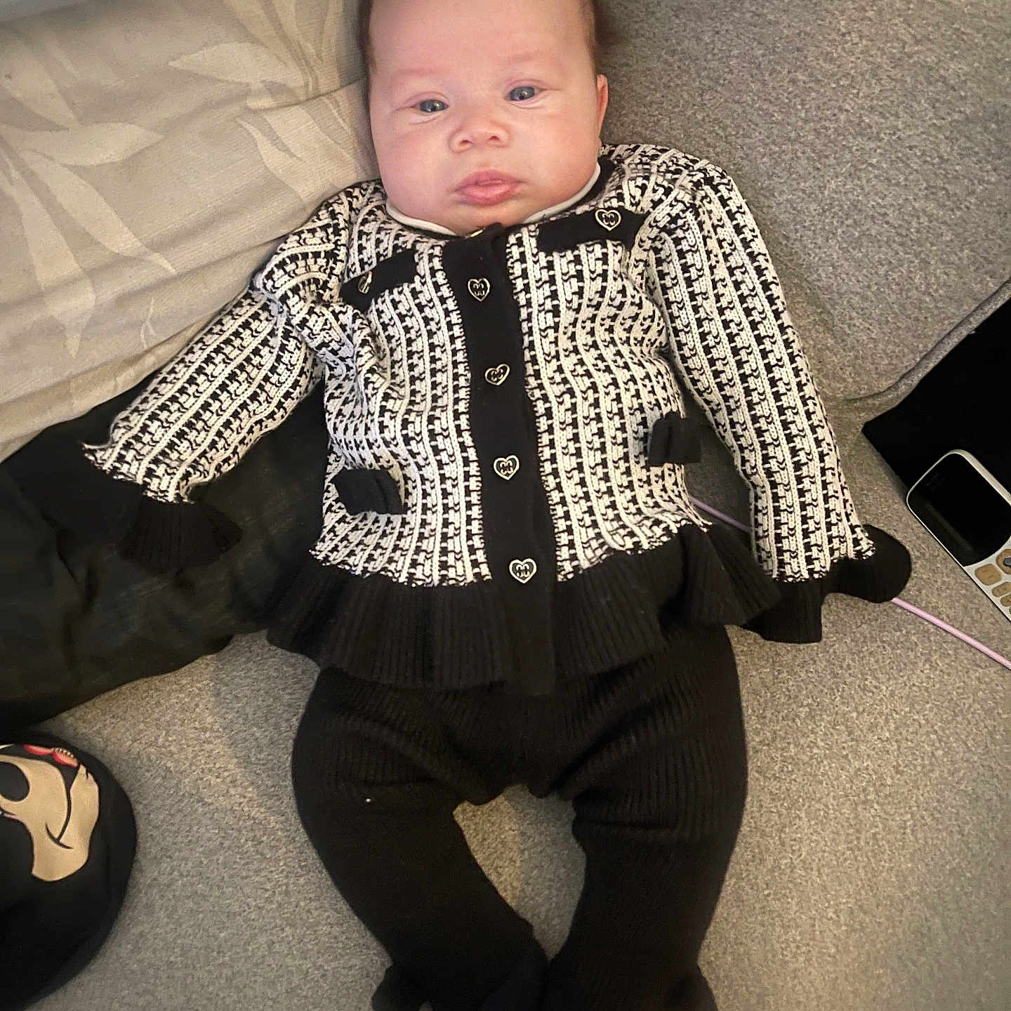 Meilani joined the competition — help win amazing prizes! baby, bodypart, clothing, coat, couch, face, finger, footwear, furniture, glove, hand, head, jacket, knitwear, pants, person, photography, portrait, shoe, sweater