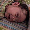 baby, sleeping, infant, closeup, striped_clothing, blanket, patterned_blanket, colorful, cozy, cute, peaceful, face, head, child, young, soft, indoors, resting, person, newborn