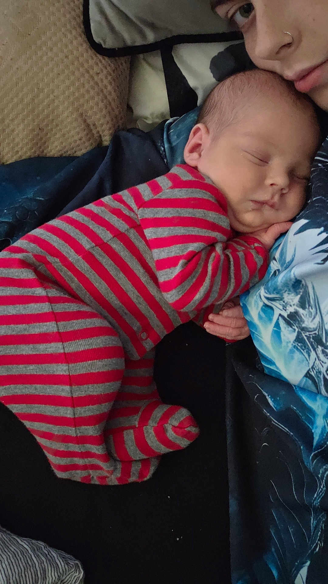 Theodore joined the competition — help win amazing prizes! baby, newborn, sleeping, striped_pajamas, person, face, couch, pillow, blanket, rest, closeup, comfort, indoor, cozy, skin, head, hand, adult, child, nap