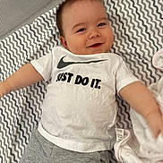 David joined the competition — help win amazing prizes! baby, smiling, tshirt, nike, just_do_it, shorts, blanket, patterned_blanket, infant, happy, lying_down, arms_outstretched, cute, child, face, clothing, indoor, person, young_child, text_on_clothing