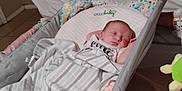 Makenzie joined the competition — help win amazing prizes! baby, bassinet, blanket, bedroom, sleeping, infant, crib, crocheted_blanket, pacifier, baby_clothing, indoor, quilt, resting, tiled_floor, bed, air_conditioner, comfort, sleep, person, soft_lighting