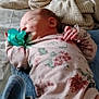 newborn, baby, sleeping, pacifier, floral_onesie, blanket, fabric, bed, infant, peaceful, cute, child, soft, resting, indoors, skin, hand, head, lying_down, cozy