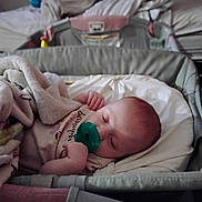 Makenzie is registered to the contest to win money with this photo: baby, bassinet, bedroom, blanket, blanket_wrap, child, comfort, cozy, cute, head, indoors, infant, nap, pacifier, peaceful, person, resting, sleep, sleeping, soft