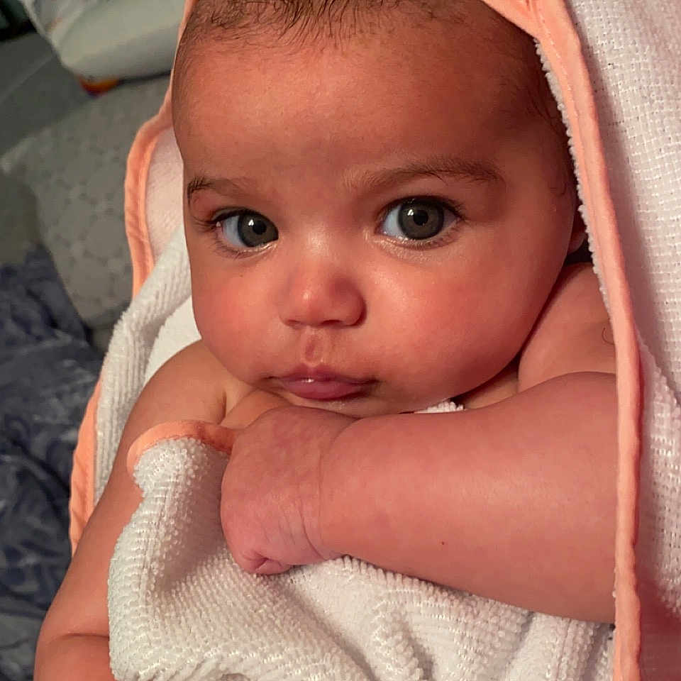 Amara is registered to the contest to win money with this photo: baby, baby_products, baby_toddler_clothing, cap, cheek, child, chin, comfort, eyebrow, eyelash, finger, iris, linens, lip, mouth, nose, skin, sleeve, thumb, toddler