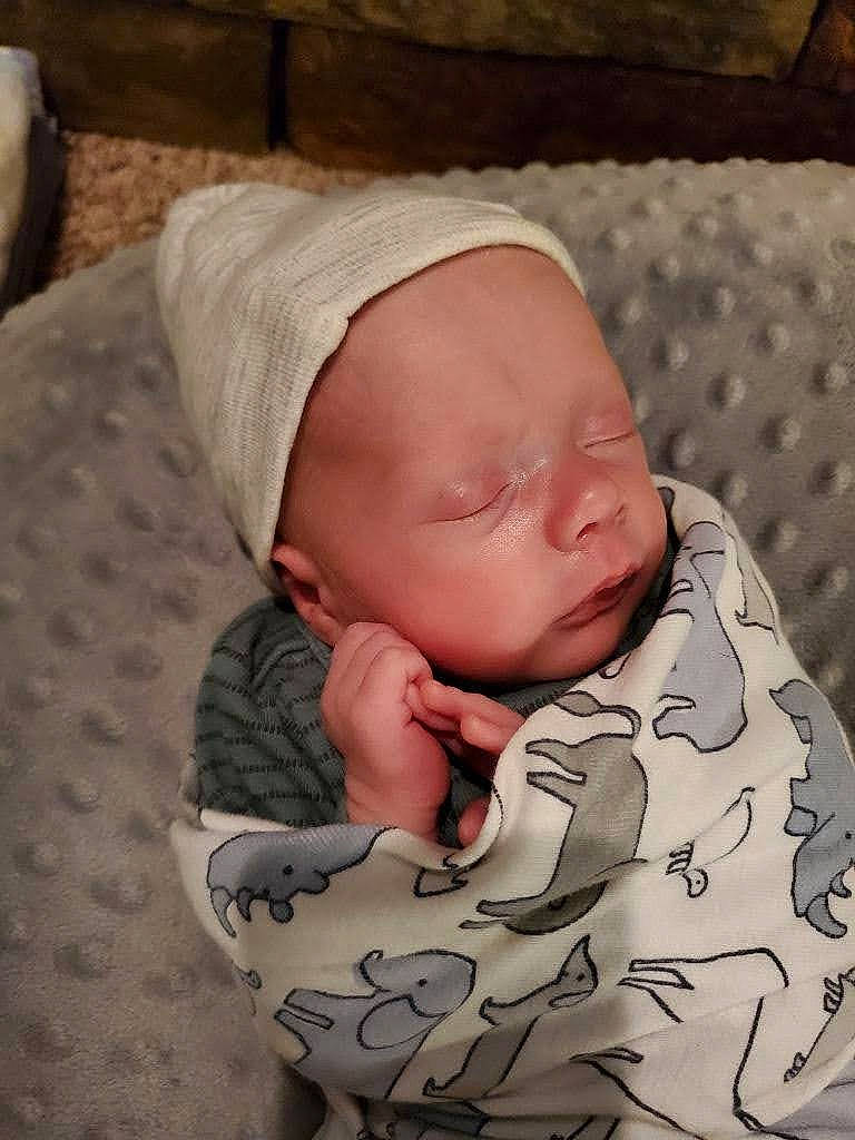 Tristan joined the competition — help win amazing prizes! baby, baby_products, baby_sleeping, baby_toddler_clothing, bedtime, cap, cheek, child, chin, comfort, face, head, headgear, linens, mouth, pattern, person, sitting, skin, sleeve