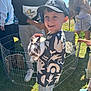 Roman joined the competition — help win amazing prizes! child, boy, rabbit, animal, petting_zoo, outdoor, sunny, cap, grass, people, fence, bird, parakeet, smile, happy, casual_clothing, nature, daylight, event, holding