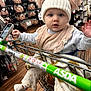 Margo joined the competition — help win amazing prizes! baby, child, shopping_cart, hat, pom_pom, blue_eyes, clothing, store, aisle, floor, bra, socks, blanket, bib, person, retail, shopping, infant, face, cute