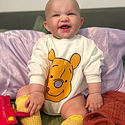 Margo joined the competition — help win amazing prizes! baby, smiling, onesie, winnie_the_pooh, yellow_socks, pillow, bed, child, happy, cute, infant, knitted_socks, soft_toys, indoor, portrait, sitting, clothing, face, person, joy