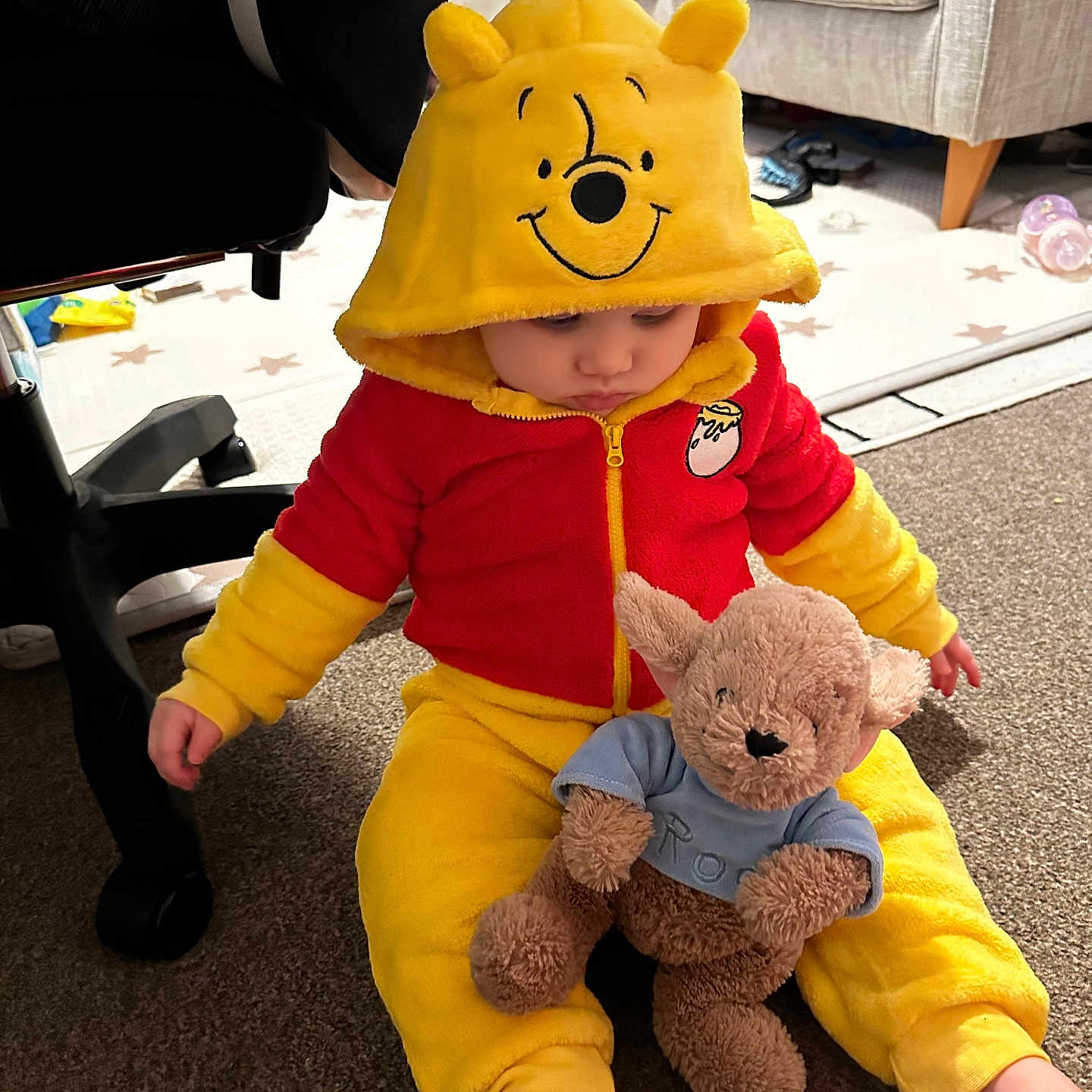 Margo joined the competition — help win amazing prizes! baby, baby_bottle, carpet, child, childwear, cozy, cute, foot, furniture, home, hoodie, indoor, plush_toy, red_clothing, sitting, sofa, stuffed_animal, toddler, winnie_the_pooh, yellow_clothing