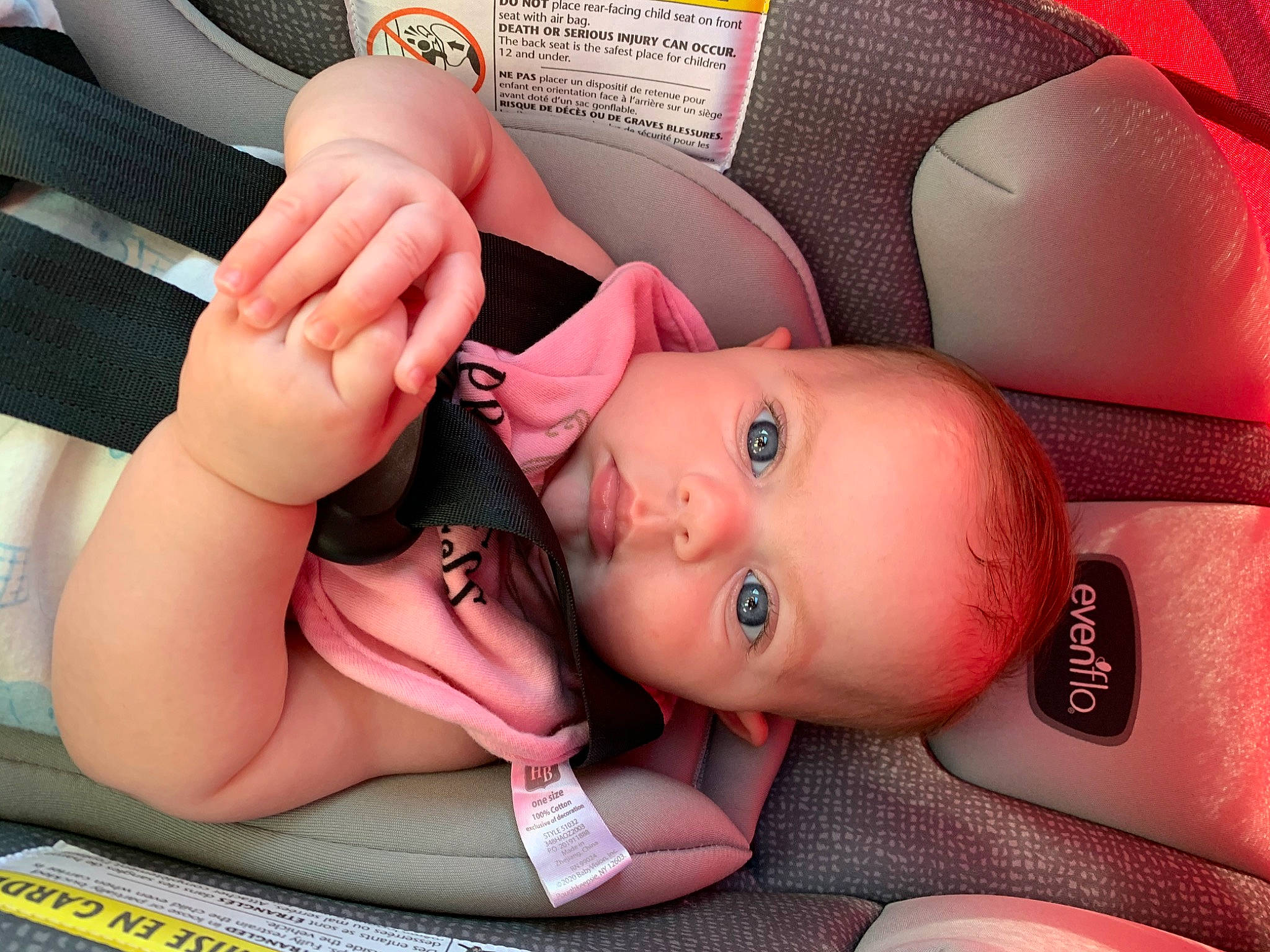 Esme is registered to the contest to win money with this photo: auto_part, baby, baby_in_car_seat, birth, car_seat, cheek, child, ear, eyelash, finger, hand, mouth, nail, neck, person, pink, product, skin, toddler