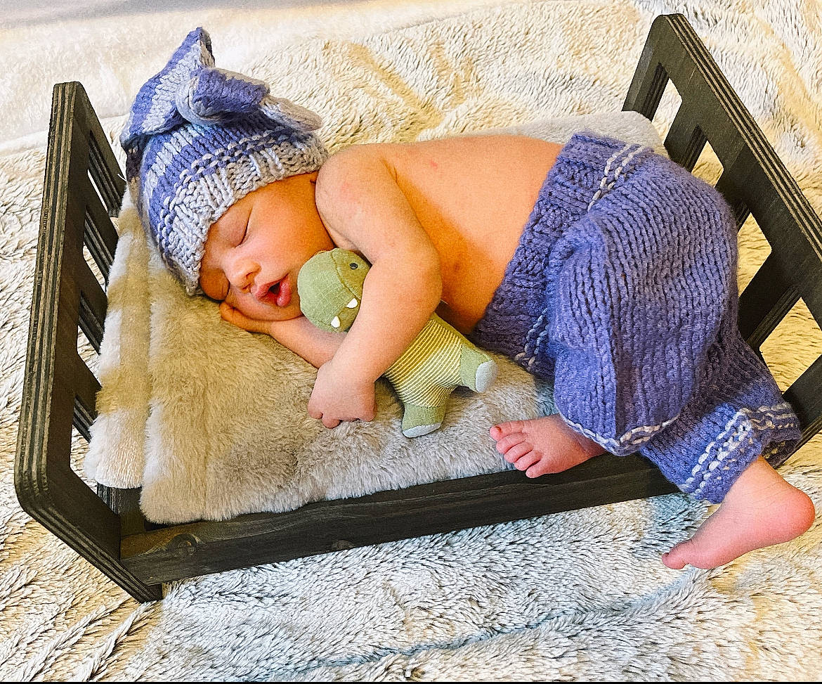 Jaxton joined the competition — help win amazing prizes! baby, baby_sleeping, baby_toddler_clothing, barefoot, comfort, electric_blue, fashion_accessory, flooring, foot, grass, headwear, human_leg, leisure, linens, pattern, person, rectangle, sitting, textile, thigh