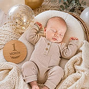 Ryland joined the competition — help win amazing prizes! baby, sleeping, infant, blanket, balloon, wooden_milestone, pajamas, cozy, celebration, soft_texture, nursery, peaceful, cute, portrait, newborn, resting, decor, neutral_colors, baby_bedding, milestone_marker