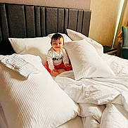 Adrian participe au concours pour gagner de l'argent avec cette photo : baby, bed, pillow, blanket, smile, child, indoors, furniture, cozy, white, comfort, headboard, clothing, room, sitting, happy, portrait, soft, home, sleep