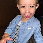 Grayson is registered to the contest to win money with this photo: toddler, child, smile, happy, onesie, clothing, indoor, carpet, couch, pacifier_clip, hand, face, person, baby, dimples, young_child, blue_clothing, zipper, fabric, cute