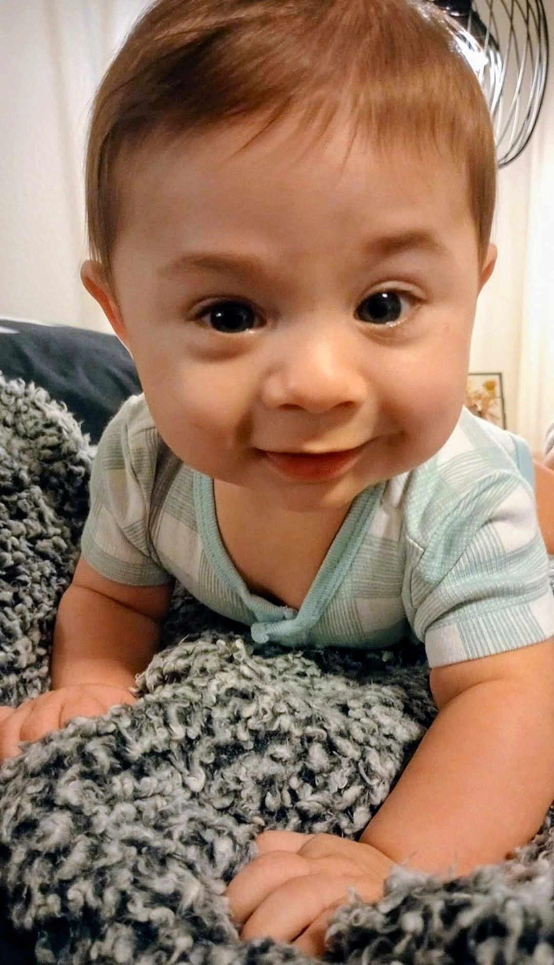 Micah joined the competition — help win amazing prizes! baby, blanket, child, closeup, cozy, crawling, curious, cute, expression, face, hands, happy, indoor, infant, light, onesie, portrait, smiling, soft_texture, young