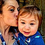 Micah joined the competition — help win amazing prizes! affection, baby, blue_shirt, child, closeup, cute, face, happy, holding, kiss, outdoor, portrait, rubber_duck, skin, smile, striped_clothing, tattoo, toy, woman, wooden_background