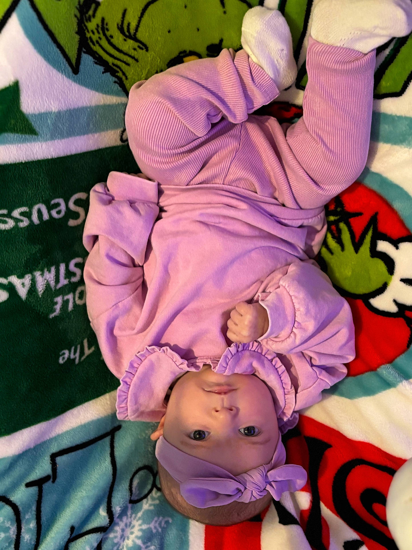 Lilyanna is registered to the contest to win money with this photo: baby, blanket, bodypart, bonnet, cap, clothing, costume, doll, face, finger, glove, hand, hat, head, newborn, person, photography, portrait, purple, toy