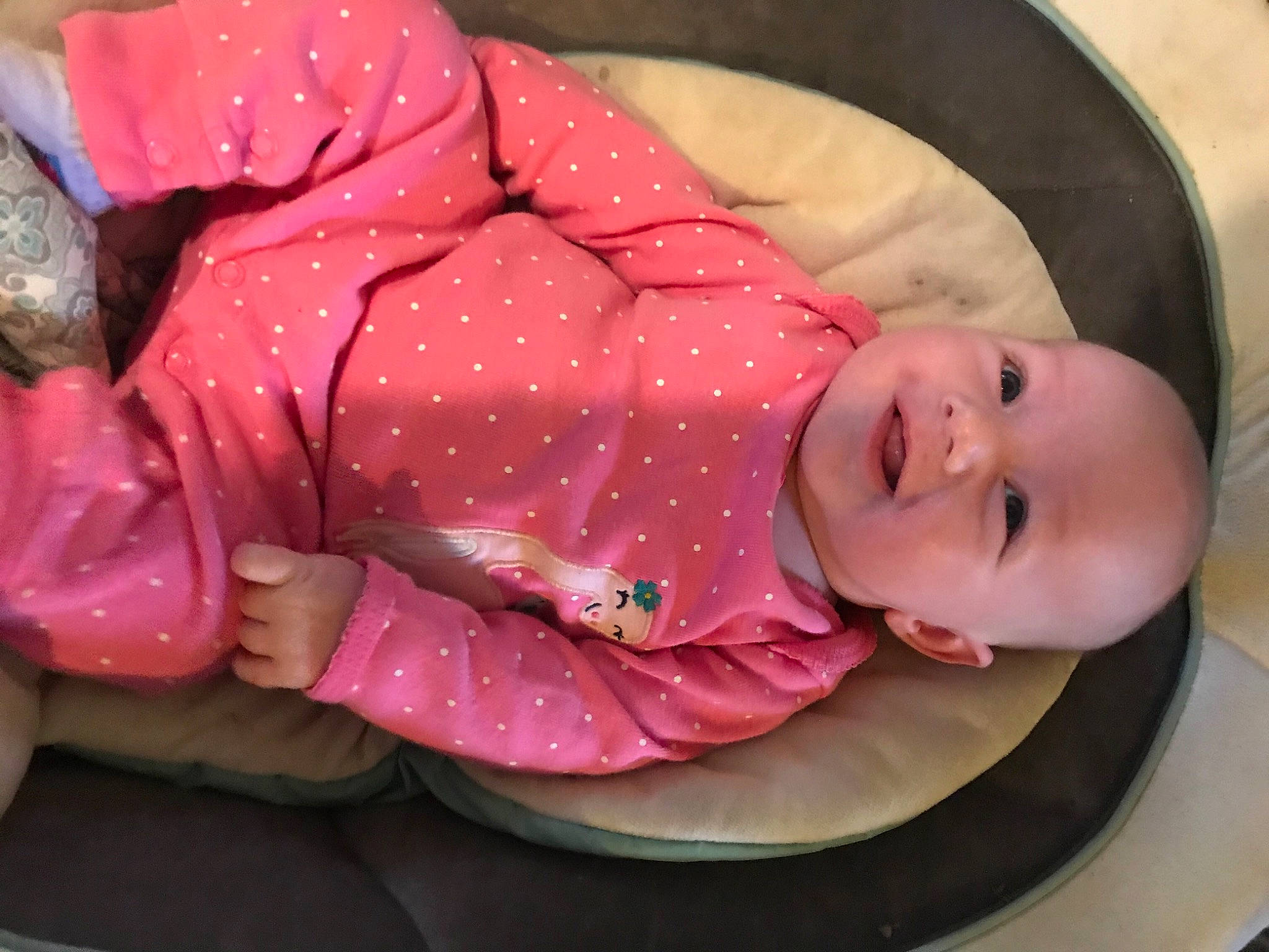 Audrey is registered to the contest to win money with this photo: baby, baby_products, baby_safety, baby_sleeping, baby_toddler_clothing, carmine, cheek, child, comfort, headgear, infant_bed, linens, magenta, mouth, person, pink, product, sitting, sleeve, smile