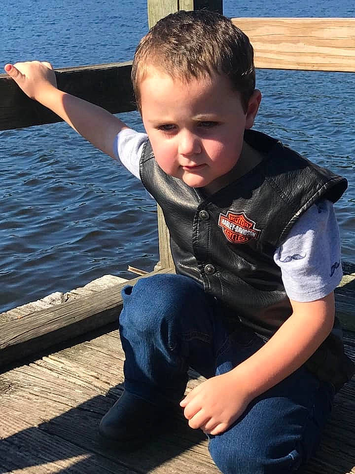 Canaan is registered to the contest to win money with this photo: child, cool, denim, electric_blue, flash_photography, fun, happy, joint, lake, leisure, person, personal_protective_equipment, recreation, sitting, sky, sleeve, standing, t_shirt, toddler, water