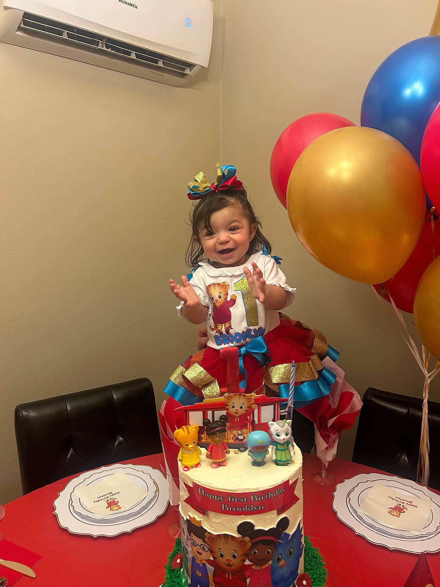 Brooklyn is registered to the contest to win money with this photo: air_conditioner, balloons, birthday, bow, cake, celebration, chair, child, clapping, decorations, dress, happy, icing, indoor, napkin, party, smile, table, toddler, toy_figures