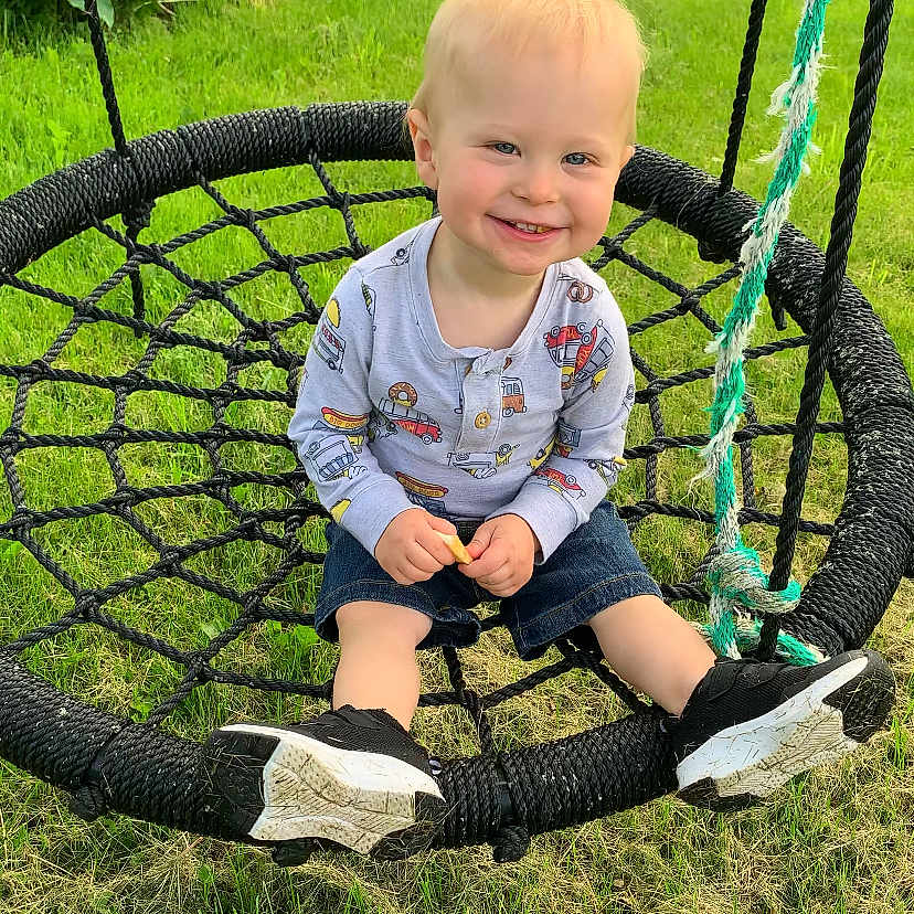 Brayden is registered to the contest to win money with this photo: baby, backyard, clothing, face, footwear, grass, happy, head, nature, outdoorplayarea, outdoors, pants, park, person, photography, plant, playarea, portrait, sitting, yard