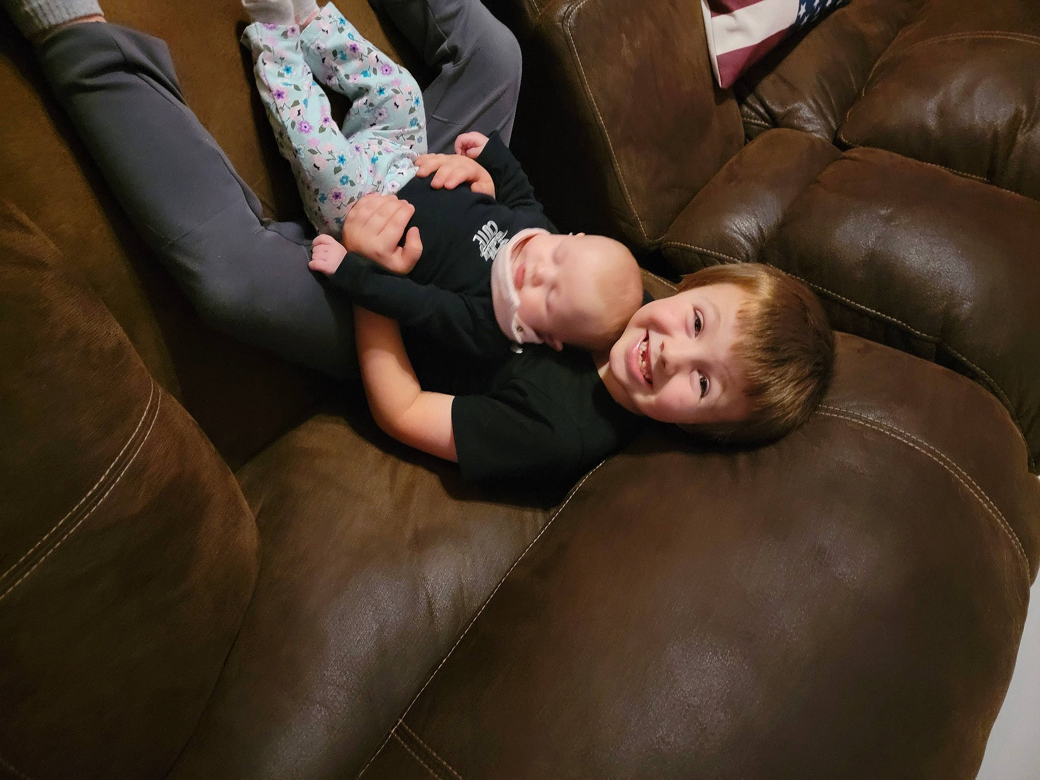 Brahmz is registered to the contest to win money with this photo: child, comfort, couch, flash_photography, flooring, fun, furniture, hardwood, human_leg, joy, knee, lap, living_room, luxury_vehicle, person, sitting, smile, sofa_bed, studio_couch, thigh