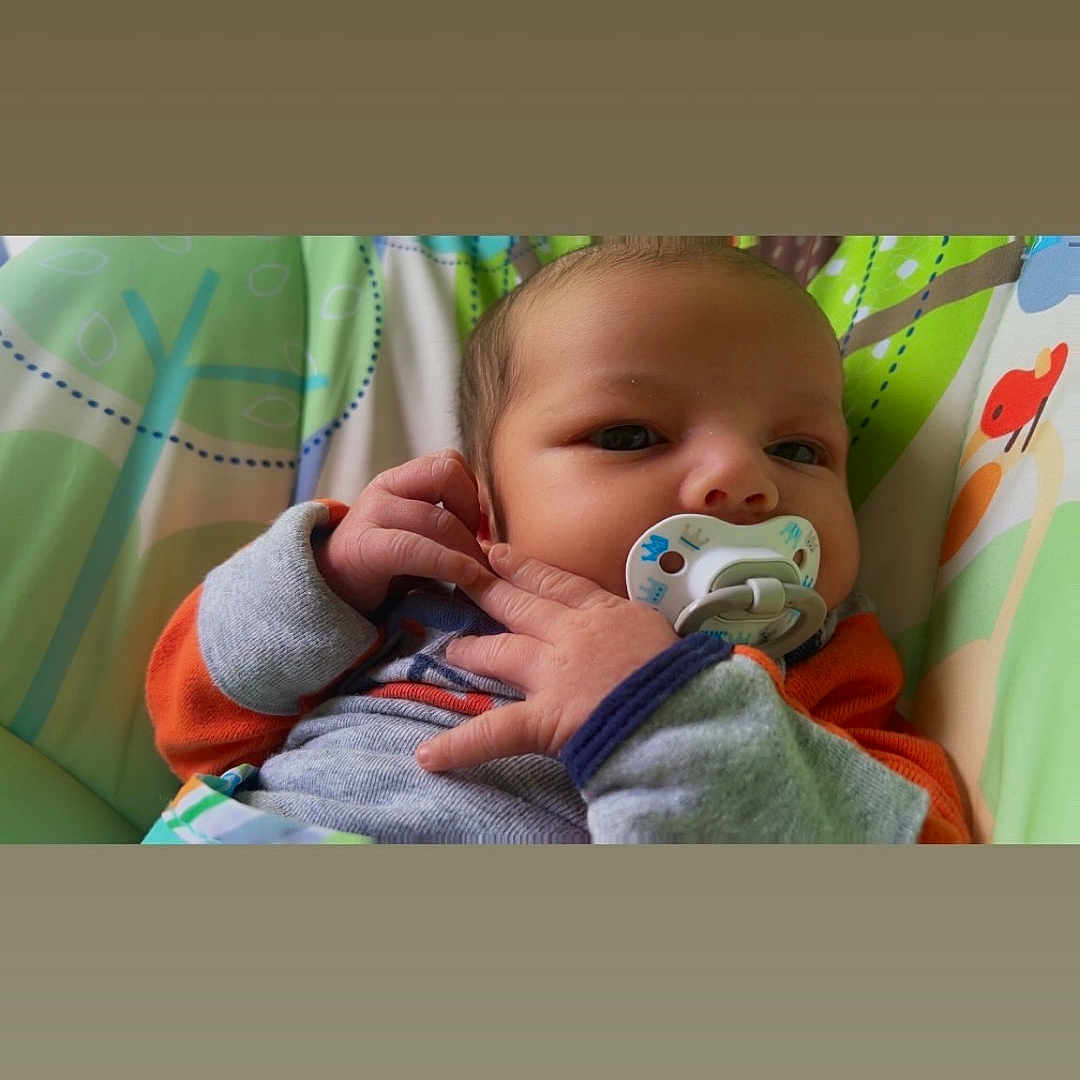 Dawson joined the competition — help win amazing prizes! baby, child, closeup, clothing, colorful, comfort, cushion, cute, face, hand, indoor, infant, newborn, pacifier, patterned, portrait, resting, skin, soft, young