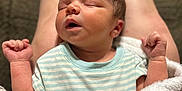 Dawson is registered to the contest to win money with this photo: newborn, baby, sleeping, blanket, striped_clothing, arms_up, closed_eyes, infant, soft_texture, legs, cozy, resting, peaceful, human, skin, portrait, indoor, relaxation, cute, tender_moment