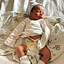Dawson is registered to the contest to win money with this photo: newborn, baby, sleeping, blanket, diaper, sock, hat, umbilical_clamp, infant, resting, soft, cute, peaceful, clothing, bed, toddler, person, skin, comfort, indoor