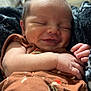 Dawson joined the competition — help win amazing prizes! baby, smiling, sleeping, infant, closeup, face, hand, cozy, brown_clothing, newborn, indoors, soft_lighting, portrait, peaceful, cute, relaxed, skin, person, toddler, baby_clothes