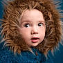 child, toddler, face, fur_hood, blue_sweater, portrait, curious, wide_eyes, cozy, warm_clothing, studio, closeup, cute, baby, winter_wear, expression, headwear, innocent, soft_texture, indoor