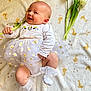Isalya a rejoint le concours — aidez-le/la à gagner de superbes lots ! baby, infant, smiling, tutu, white_clothing, flower, tulip, blanket, duck_pattern, sock, cute, happy, lying_down, child, soft_texture, indoor, adorable, celebration, spring, toddler