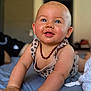 arms, baby, bed, blanket, blue_eyes, child, closeup, clothing, crawling, cute, drool, focus, happy, indoors, infant, necklace, person, portrait, skin, smiling