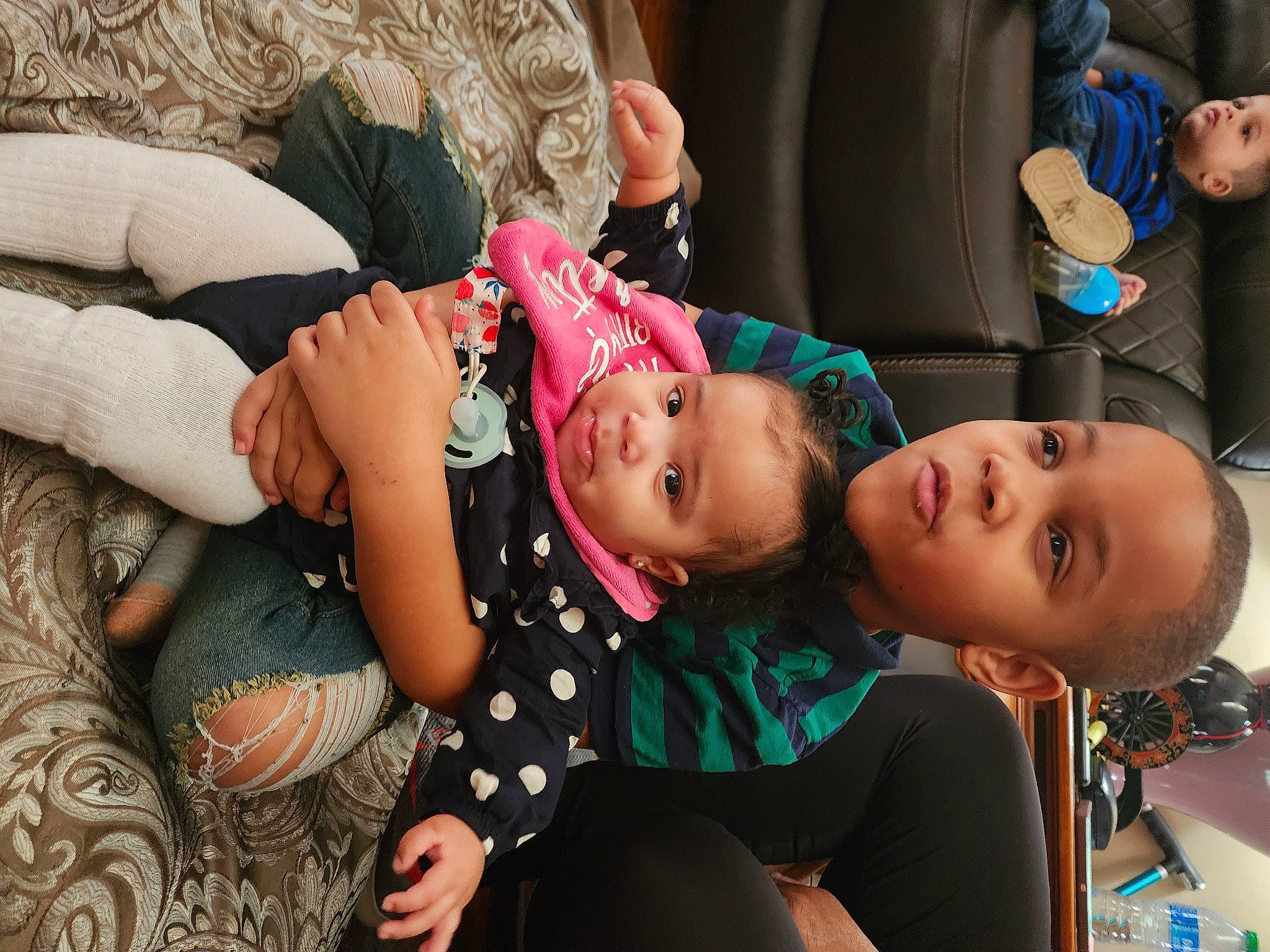 Italia is registered to the contest to win money with this photo: abdomen, baby, black_hair, child, costume, couch, eyelash, fashion_accessory, fashion_design, fun, happy, human_leg, jewellery, leisure, neck, pattern, person, room, skin, thigh