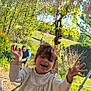 Neilia participe au concours pour gagner de l'argent avec cette photo : child, smiling, outdoor, garden, flower, tree, greenery, sunlight, happy, playful, person, nature, purple_flower, casual_clothing, young_child, daylight, grass, bush, joyful, portrait