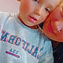 child, adult, selfie, close_up, sweatshirt, indoor, face, portrait, smile, skin, sparkle_effect, casual_clothing, blond_hair, young, parent_child, affection, warmth, cute, touching_faces, soft_filter