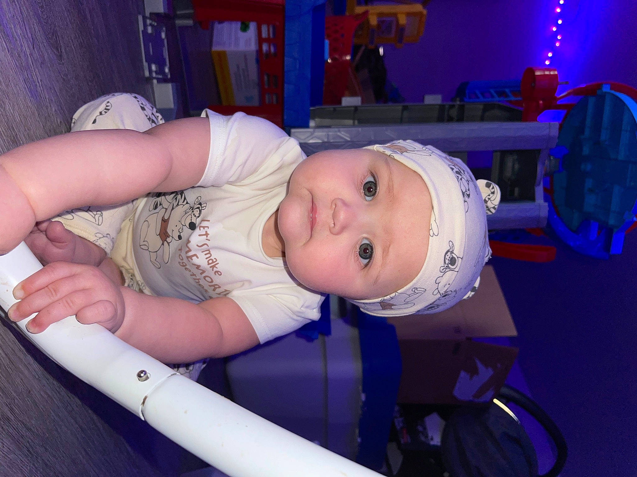 Ivy is registered to the contest to win money with this photo: baby, baby_products, baby_safety, baby_toddler_clothing, chair, child, electric_blue, fun, hat, headwear, helmet, machine, person, product, room, sitting, skin, smile, toddler, wheel