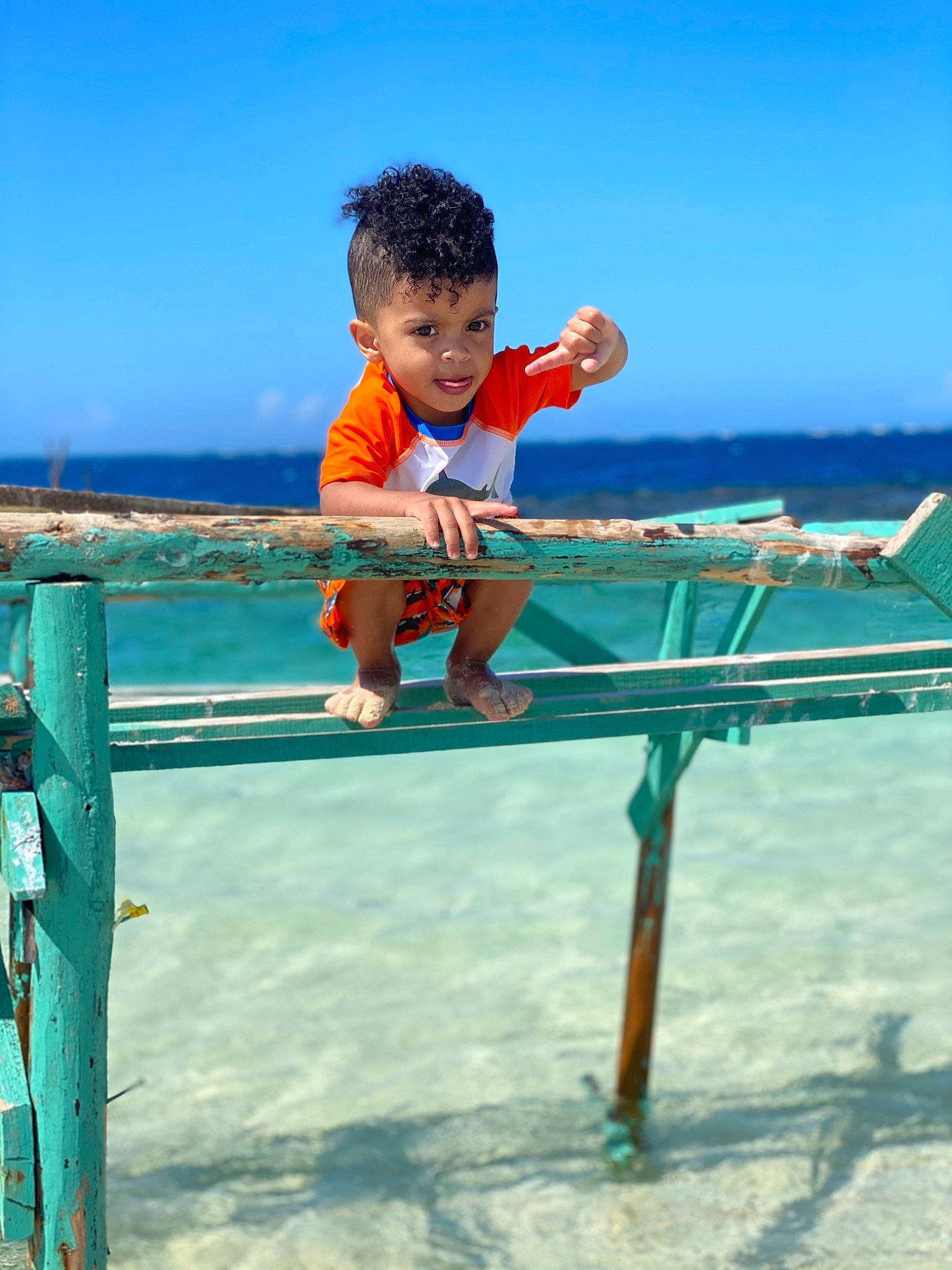 Darwin is registered to the contest to win money with this photo: beach, blue, child, coast, fun, happy, jumping, leisure, ocean, outdoor_furniture, person, play, sand, sea, sky, smile, summer, toddler, tourism, vacation