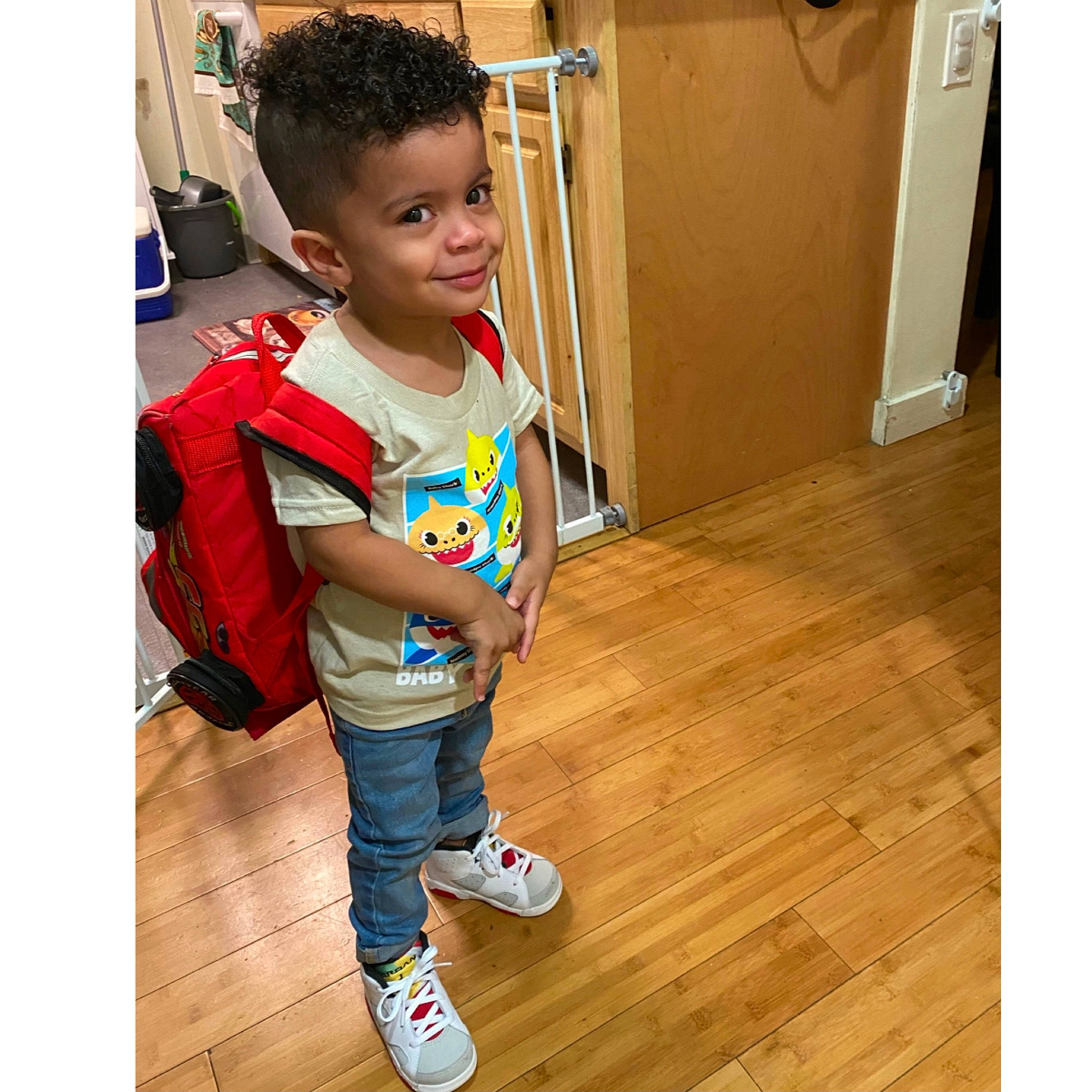 Darwin is registered to the contest to win money with this photo: child, clothing, denim, flooring, footwear, happy, jacket, jeans, joy, outerwear, person, play, shoe, shoulder, sleeve, standing, t_shirt, toddler, trousers