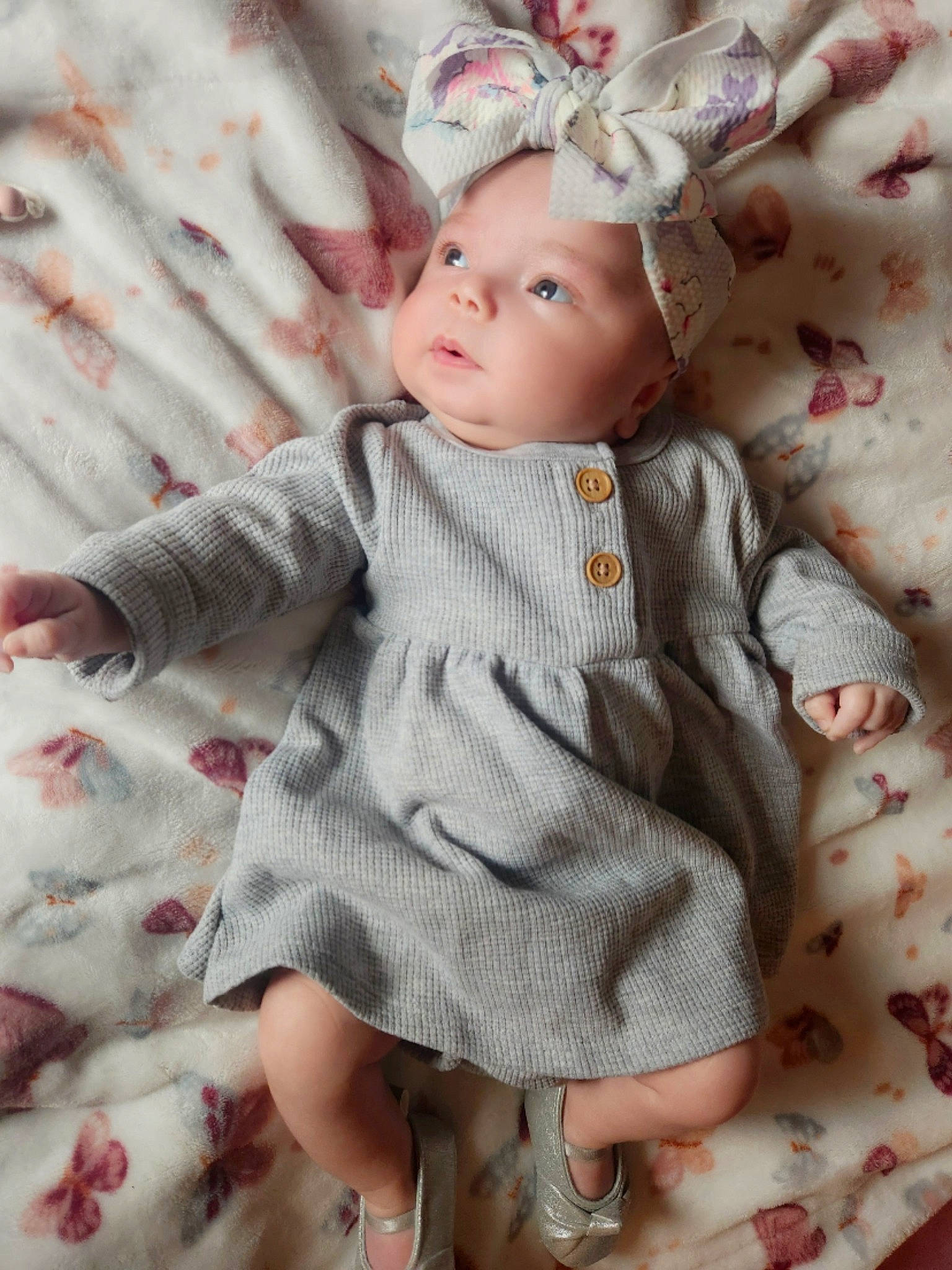 Ava is registered to the contest to win money with this photo: baby, baby_toddler_clothing, brown_hair, cheek, child, doll, dress, eye, eyelash, headwear, iris, linens, lip, pattern, person, pink, skin, sleeve, textile, toddler