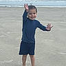 Raylon is registered to the contest to win money with this photo: child, beach, ocean, sand, waves, boy, smiling, barefoot, blue_clothing, bird, ship, sky, water, playful, outdoor, portrait, fun, happy, summer, vacation