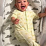 Joaquin joined the competition — help win amazing prizes! baby, infant, crib, onesie, yellow_clothing, smiling, happy, cute, child, bed, sleeping_area, patterned_bedding, duck_pattern, cloud_pattern, reaching_out, face, person, indoors, soft_lighting, mesh_sides