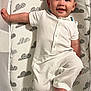 Joaquin joined the competition — help win amazing prizes! baby, infant, onesie, smiling, lying_down, bassinet, mesh_sides, mattress, cloud_pattern, white_clothing, cute, happy, child, indoors, foot, hand, head, face, sleeping_area, comfort