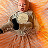 Astonn joined the competition — help win amazing prizes! baby, infant, two_months, child, portrait, lying_down, blanket, striped_blanket, knitwear, gray_clothing, milestone_card, text, cozy, warm_lighting, indoors, face, eyes_open, open_mouth, photography, newborn