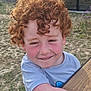 child, curly_hair, red_hair, smile, rosy_cheeks, outdoor, grass, wooden_table, tshirt, happy, face, person, nature, sunlight, freckles, cute, playful, young, boy, casual