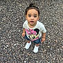 Malani is registered to the contest to win money with this photo: toddler, child, outdoor, rocks, curious, standing, minnie_mouse, tshirt, denim_shorts, white_sneakers, person, legs, bench, casual_clothing, daylight, expression, young_child, hair_tied, ground, playground