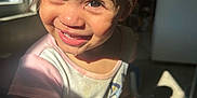 Malani is registered to the contest to win money with this photo: toddler, child, smiling, indoor, sunlight, window, face, happy, person, short_hair, clothing, holding, toy, shadow, bright, skin, closeup, expression, young_child, casual